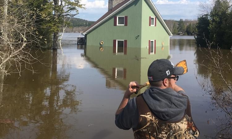 The cottage of John and Sheila Fitzpatrick on Kennebecasis Island has fallen victim to the record-setting flood. Here, John Fitzpatrick Jr. surveys the damage on Sunday. Photo: Courtesy of John Fitzpatrick Sr.